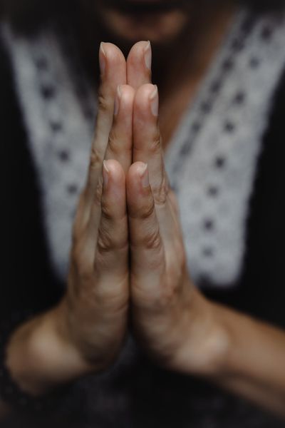 Close-up of a person's hands in a graceful mudra position.